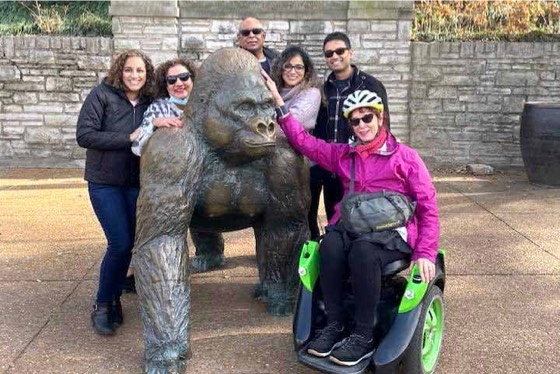 Posing with a gorilla statue in an Omeo